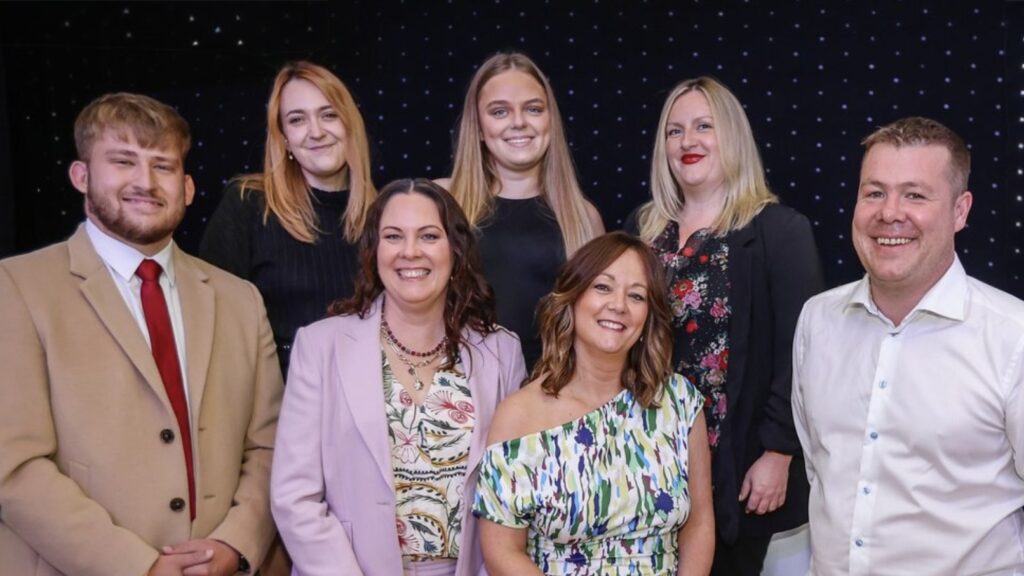 Dunore Connections team on stage winning an award